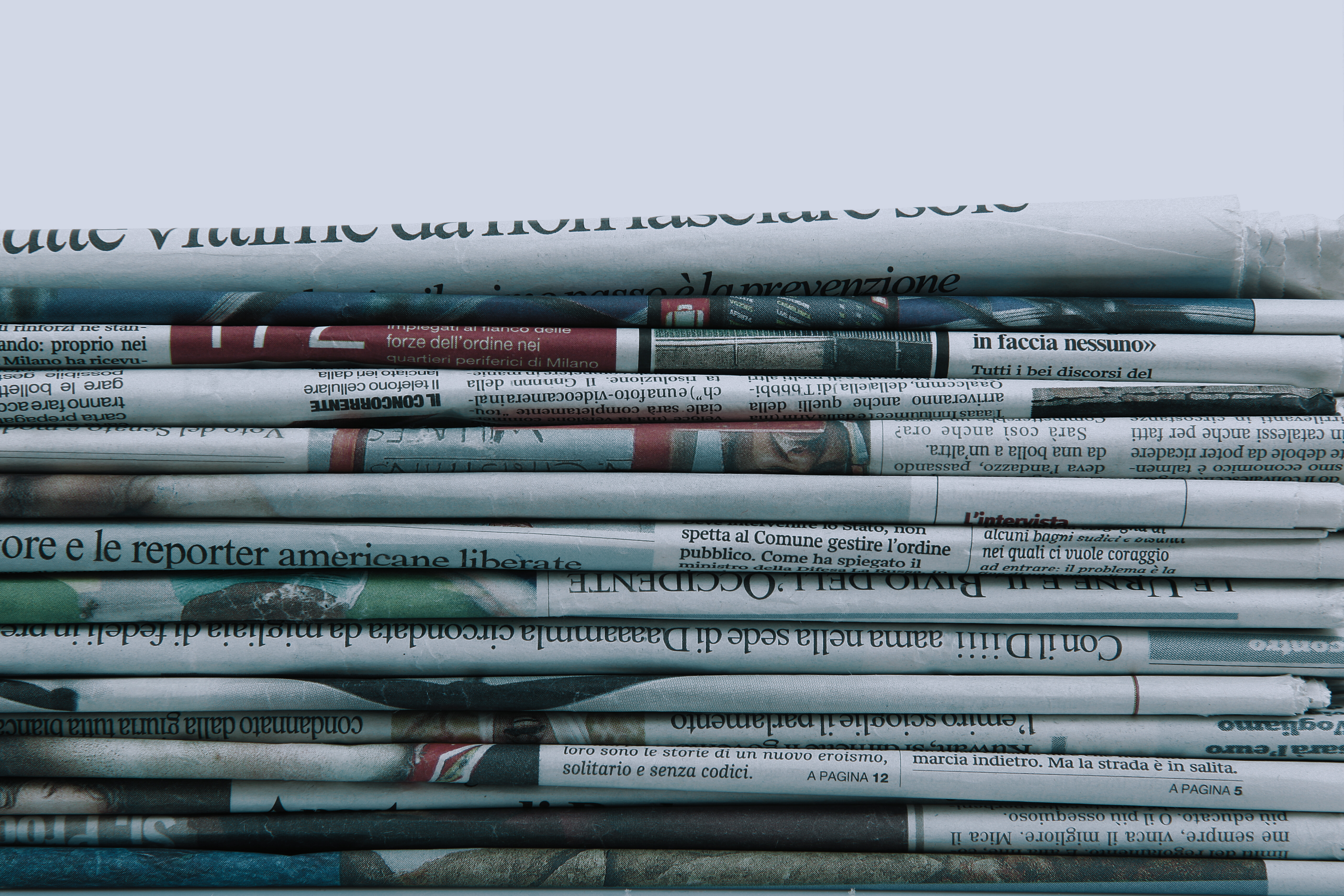 stacked newspapers with a white background