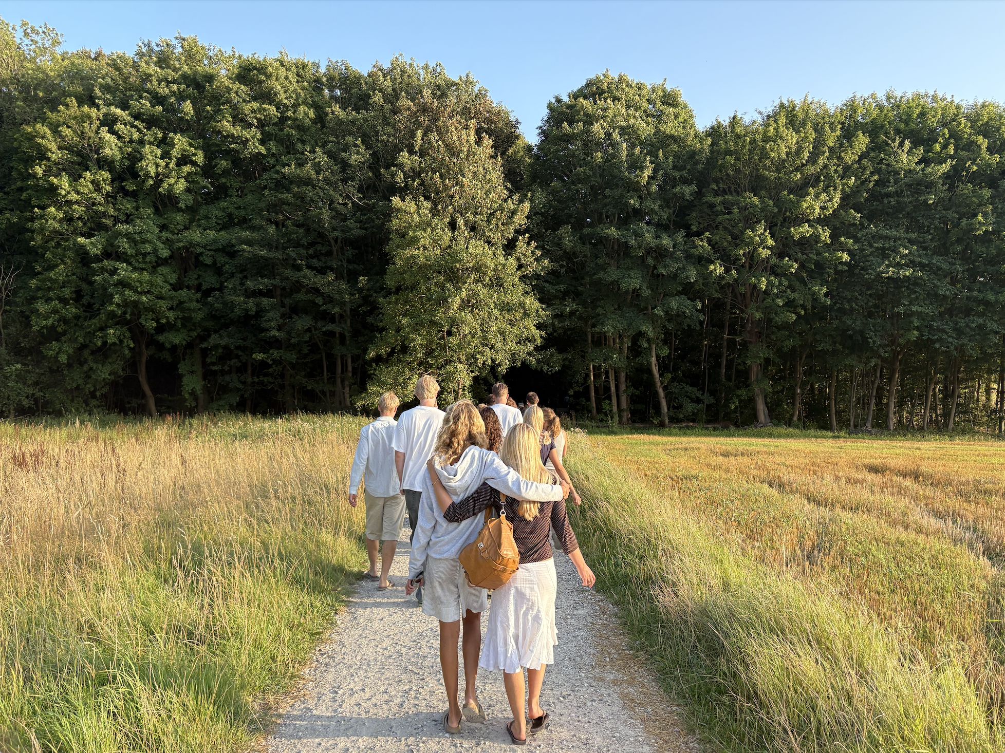People walking through landscape, arm in arm