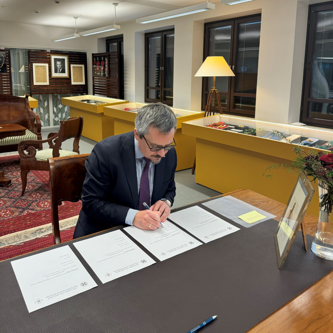 Jakob signing papers